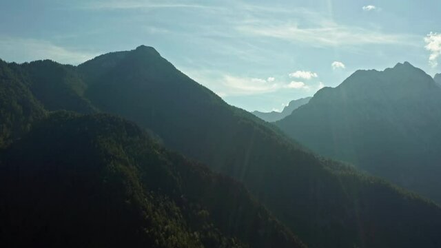 Aerial view nature of the Alps. Mountain ranges in the smog at dawn in a beautiful mountain landscape with forests covering the peaks.