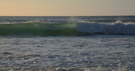 Fuerteventura, west coast, powerful ocean waves at sunset time, partially translucent