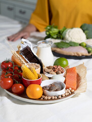 Elimination diet concept. A woman avoids food allergens - fish, seafood, dairy, peanuts, tree nuts,...