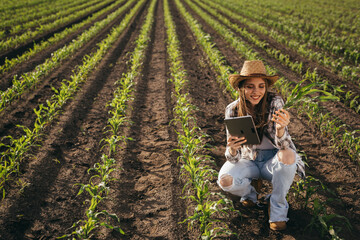woman farmer examine corn plant outdoor