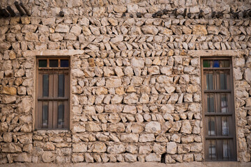 Doha,Qatar,05,10,2019. Old wooden windows in Arabic style on a traditional mud building in the market Souk Waqif.