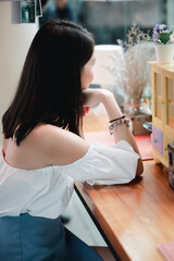 Portrait of young Asian beautiful cute girl in cafe, lifestyle concept