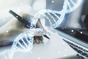 Creative concept with DNA symbol illustration and hand writing in notebook on background with...