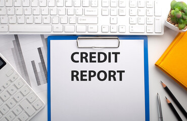 CREDIT REPORT written on paper with keyboard, chart, calculator and notebook