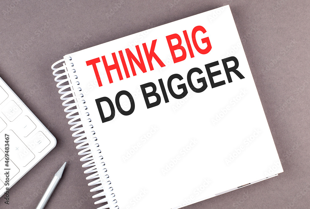 Poster think big do bigger text on the notebook with calculator and pen