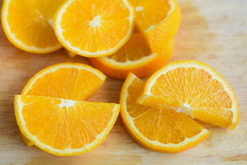Mandarin oranges are cut in half without seeds. placed on a wooden chopping board.
