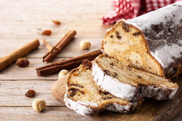 Traditional German Christmas stollen on wooden table. Copy space	