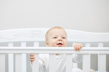 Portrait of a peaceful cute kid lying on the bed while sleeping. The correct daily routine for...