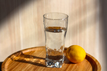 A glass of water and lemon . Morning beginning after waking up. Healthy lifestyle