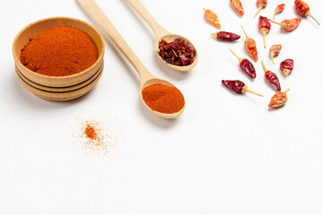 Dry paprika petals in bowl, dry pepper pods and ground paprika in bowl.