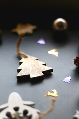 Various Christmas ornaments and colorful sequins on dark background. Selective focus.