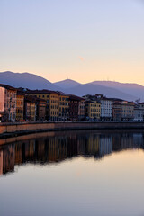 the church of Pisa, tuscany, italy, beside the river and the reflection of the colorful houses