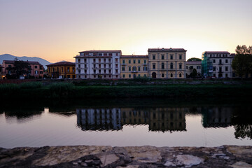 the church of Pisa, tuscany, italy, beside the river and the reflection of the colorful houses