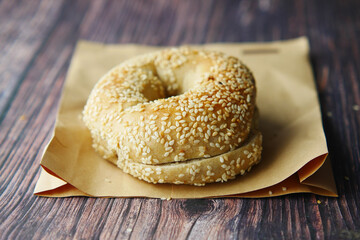 fresh bagel bread in a paper on table 