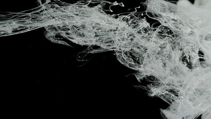 Beautiful milky white awesome abstract background. White acrylic ink in water on a black background.