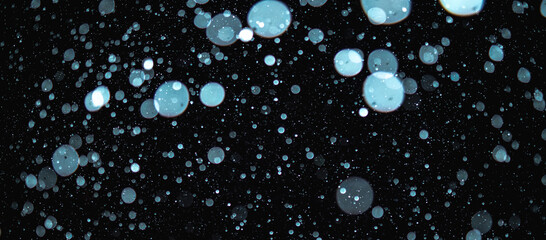 Blurred snowflakes on a dark background. Overlay image for snowfall effect