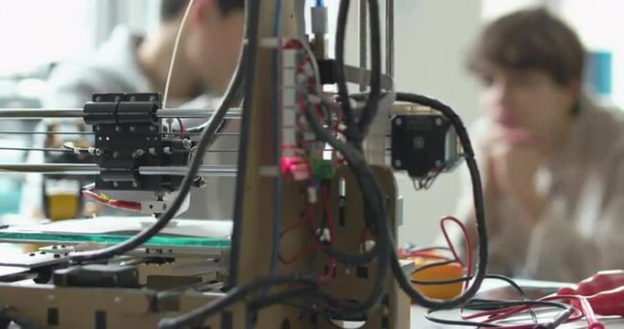 Students learning 3D printing in the lab