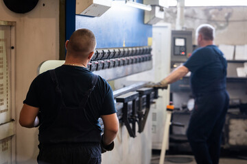 Workers work on sheet metal bending machines