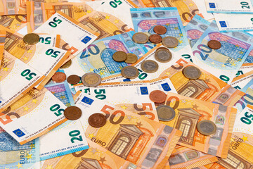 Fototapeta na wymiar coins on the background of euro banknotes, Euro bill as part of the economic and trading system