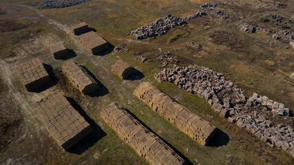 Haymaking. Flying over the large open warehouse of straw bales on an industrial scale. Ukraine