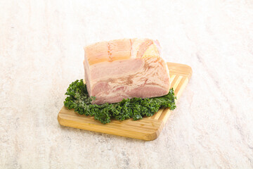 Cut of pork bacon over board