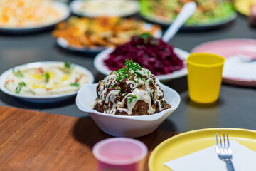 One whole head of roasted cauliflower with roasting ingredients and tahini sauce. Middle Eastern Health Diet. Mediterranean and Balkan food. High quality photo