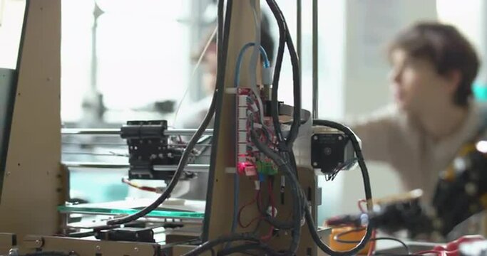 Students learning 3D printing in the lab