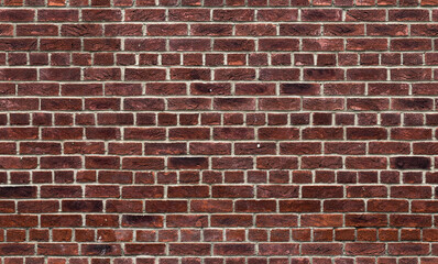 Red brick wall background with copy space. The file is a seamless texture, allowing the picture to be tiled, in order to create the effect of much bigger wall.