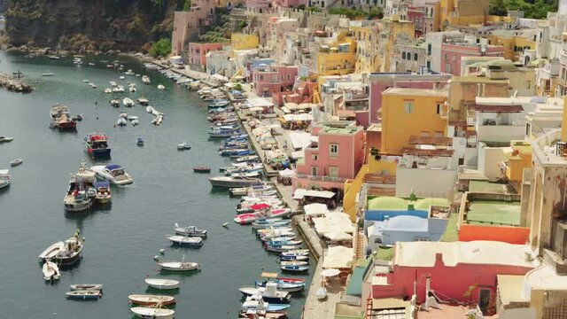 Procida, Marina Corricella, Italy. Landscape, boats, sea, Italian, island, colors, houses, summer, panorama, beautiful, port, marina / 4K Video Footage