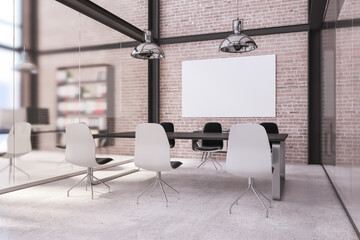 Modern loft brick and concrete coworking office interior with empty white mock up poster, furniture, computer monitors and sunlight. Workplace, design and room concept. 3D Rendering.