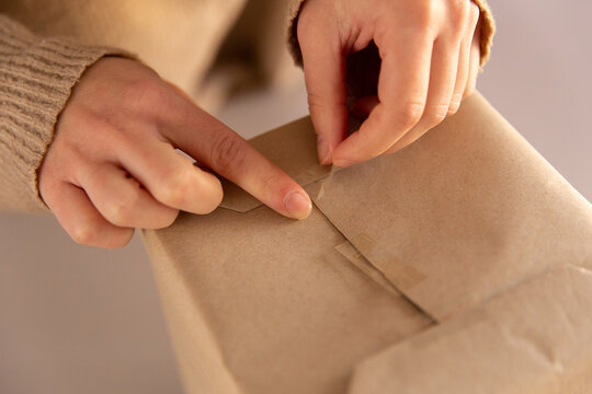 Taping wrapping paper on a present