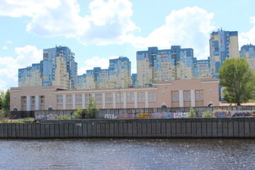 Nizhny Novgorod city - view from the Volga River. Beach, graffiti, newly built residential buildings.