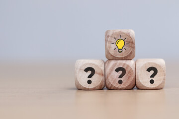 Question mark and light bulb on wooden blocks lined up. Ideas, question mark ideas.