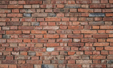 Fototapeta premium Wall built of jointed red bricks