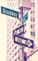 One Way traffic signs at Broadway road, color toning applied, selective focus, New York City, USA.