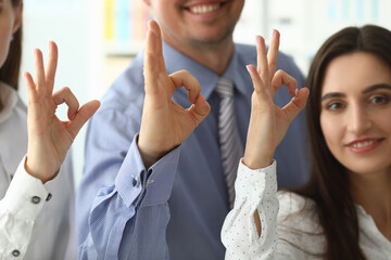 Focus on tender female and male hands showing ok gesture and posing