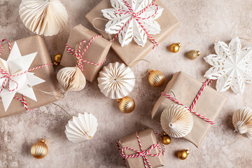 Christmas gift boxes decorated with snowflakes made of paper.