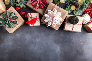 Christmas gift boxes decorated with red, green, white snowflakes made of paper.