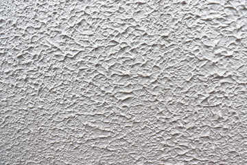 Concrete wall with texture, painted in white, to use as background.