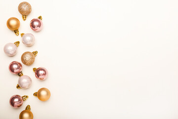 Christmas composition. Christmas  pink and gold decorations on white background. Flat lay, top view, copy space
