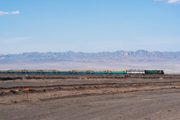 A landscape view of Naein, Iran, in May 2018, featuring a vast plain with rolling hills and a clear sky, capturing the natural beauty of the region.