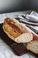 Artisan sourdough bread on wooden cutting board. Selective focus