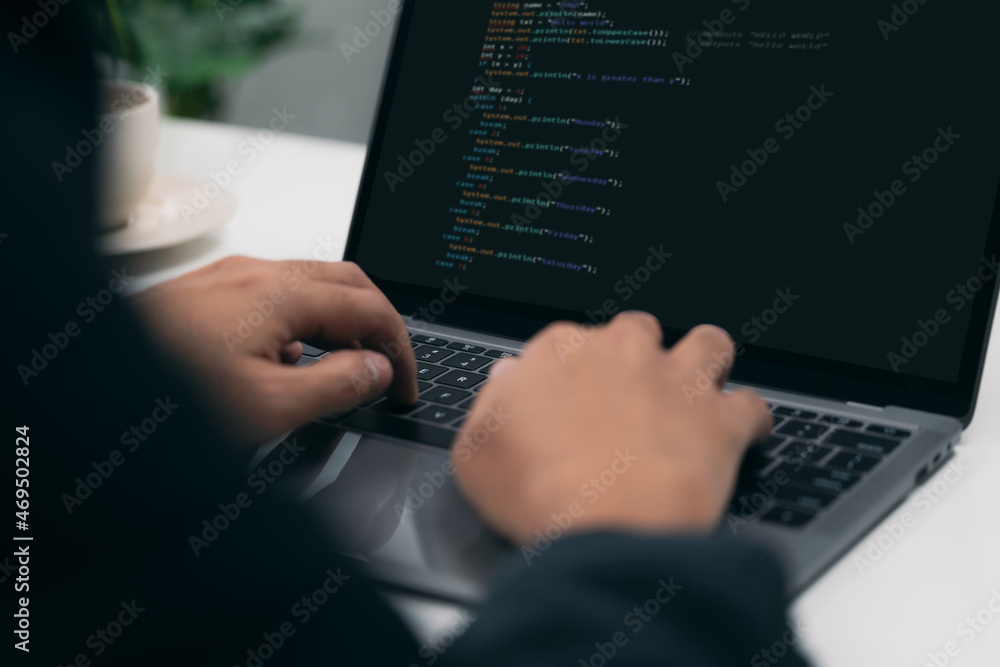 Fototapete Closeup of a man's hands coding HTML and programming on a laptop screen, web development, developer.