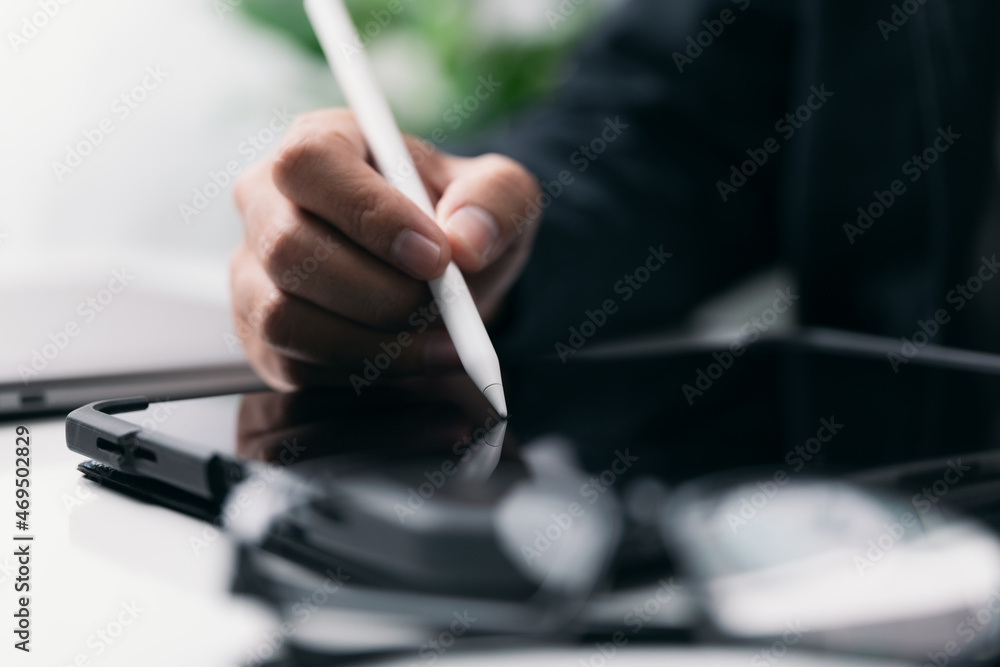 Poster businessman working with a stylus pen on a digital tablet with a laptop computer in a modern workpla