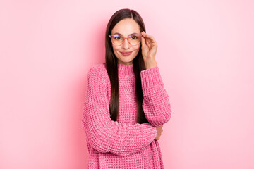 Photo of lovely young brunette lady try eyewear wear pink pullover isolated on pastel color background