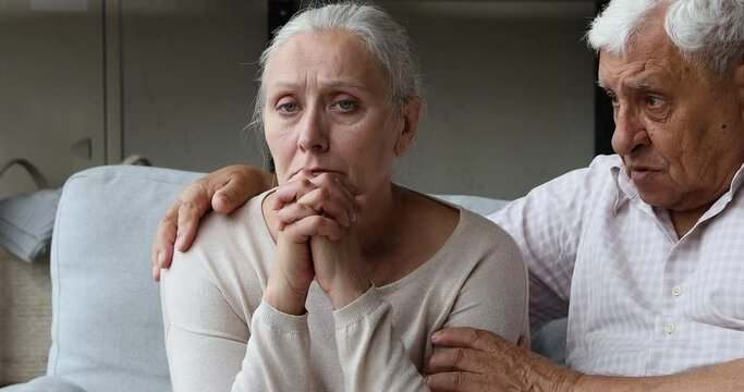 Guilty elderly man hug shoulder of resentful nervous wife ask forgiveness apologize admit he was wrong. Senior adult husband embrace spouse suffering after quarrel try to make peace after family fight