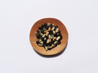 Black seeds of snake beans on a wooden plate