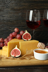 Concept of cooking eating with hard cheese on dark table