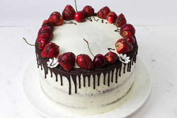 Naked Cake with chocolate drops, strawberries and cherries