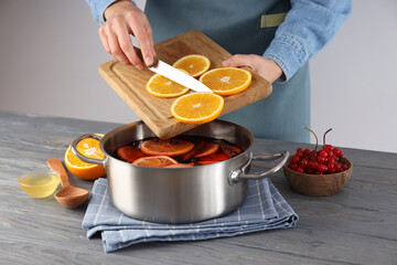 Concept of cooking  mulled wine on gray table